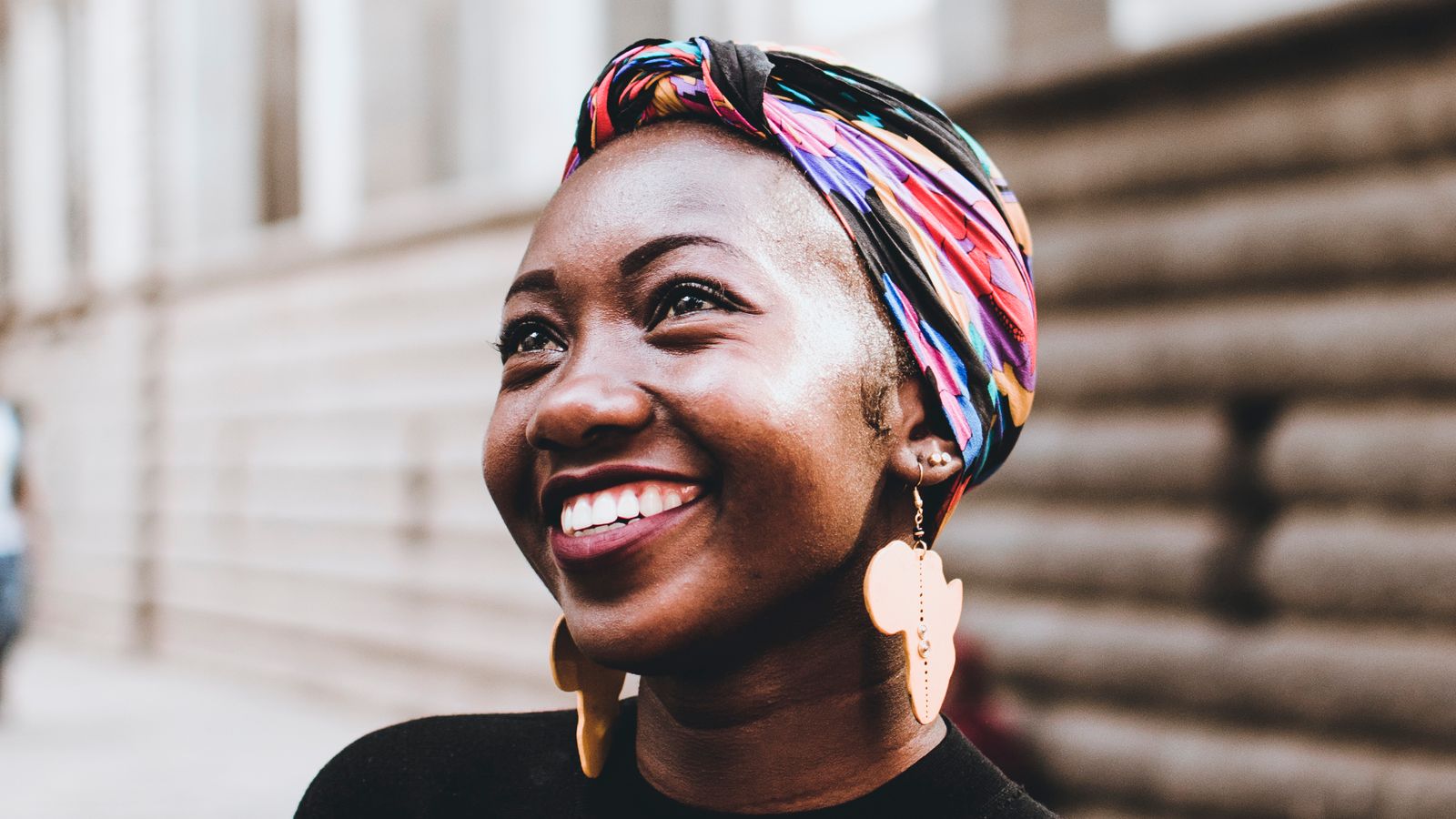 Confident woman wearing a headscarf, living with alopecia areata
