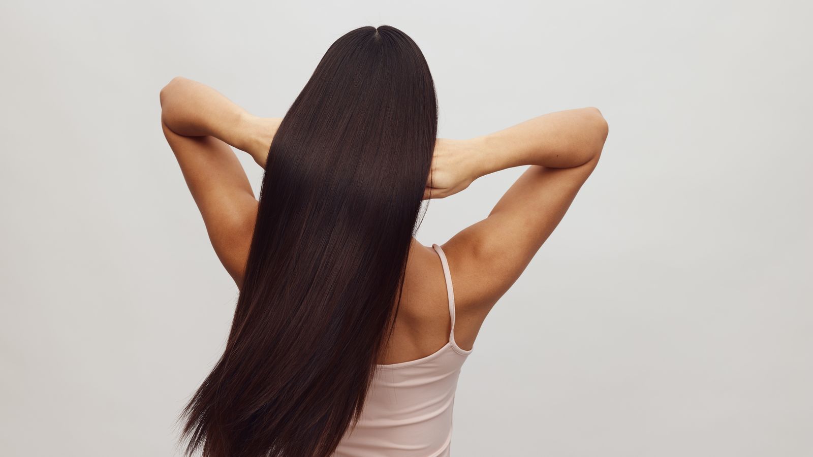 Woman with long healthy hair seen from behind, illustrating the anagen phase of the hair growth cycle
