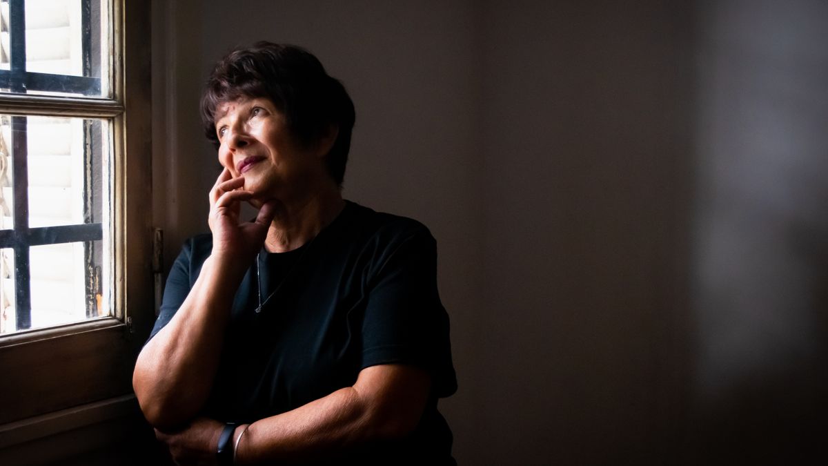 Older woman looking thoughtfully out of a window, reflecting concerns about B12 deficiency and memory loss