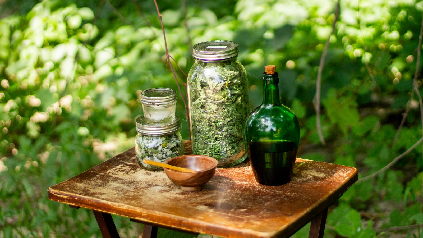 Jars of dried herbs used for hair growth oil infusions