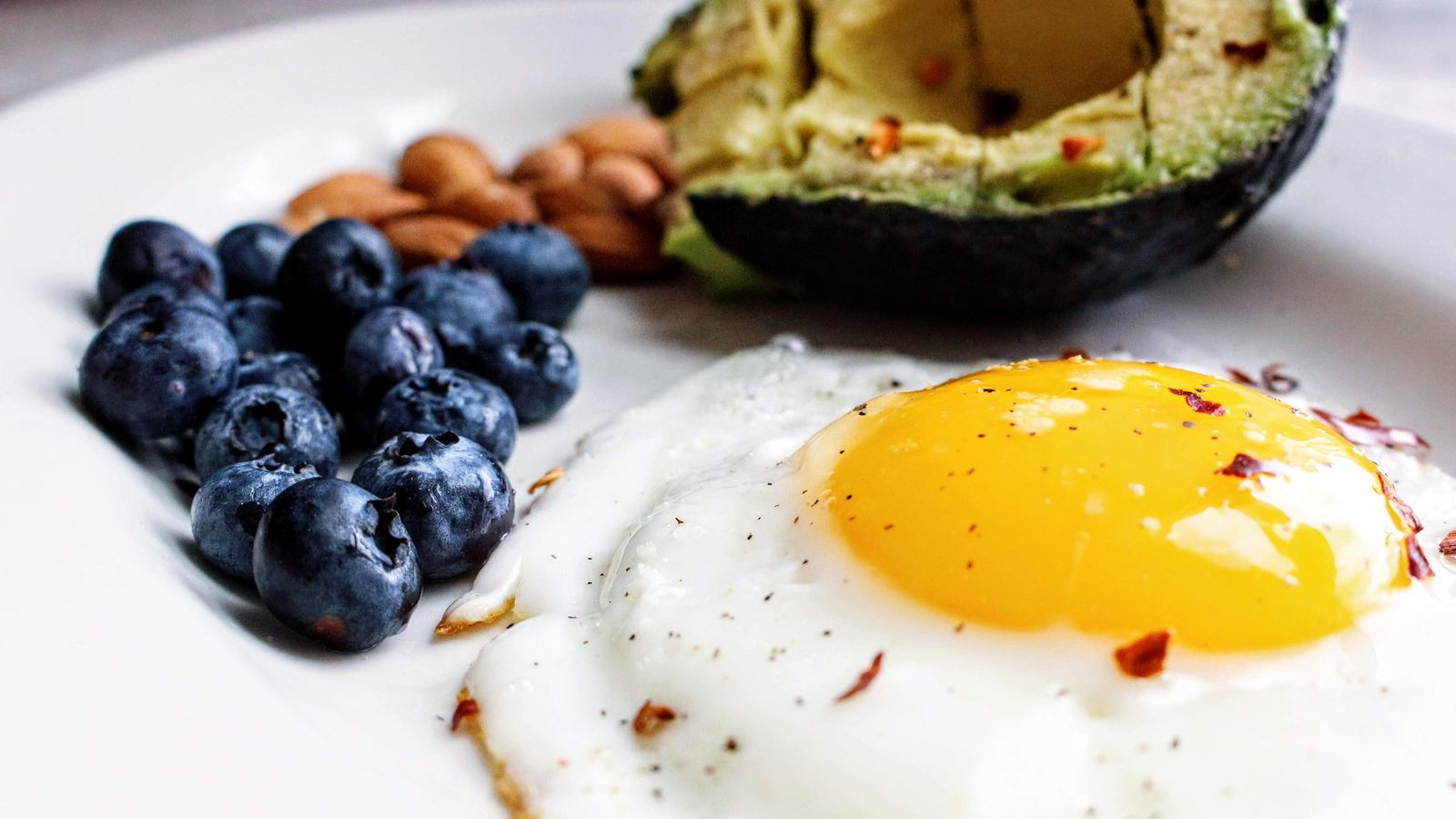 Biotin rich foods including egg, avocado, blueberries and almonds for biotin for hair growth