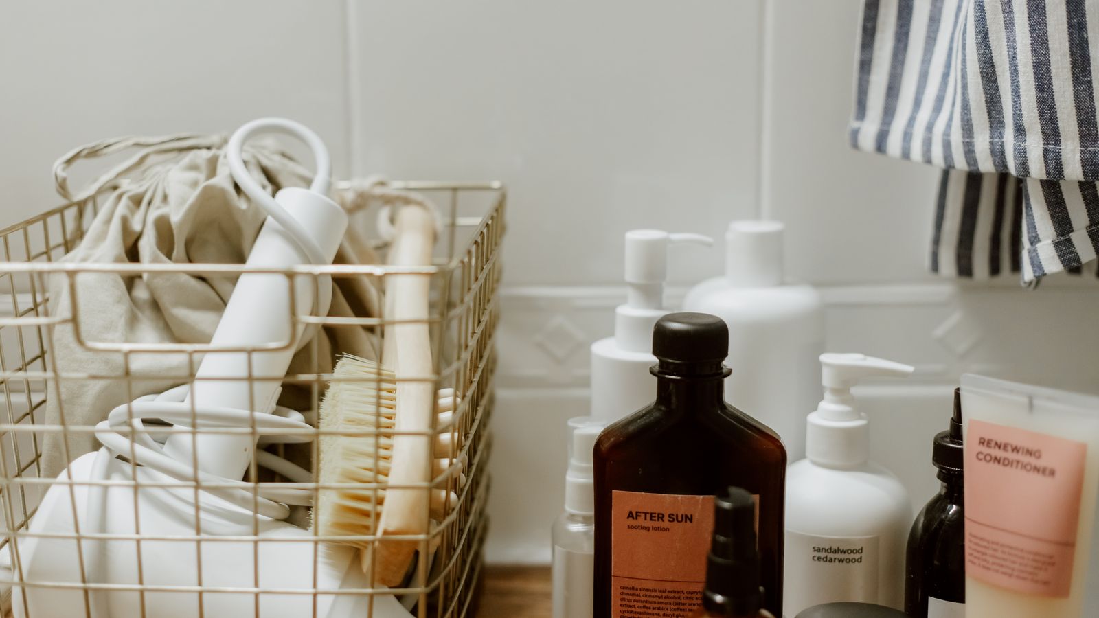 Simple bathroom products in a basket, the basis of a budget hair care routine