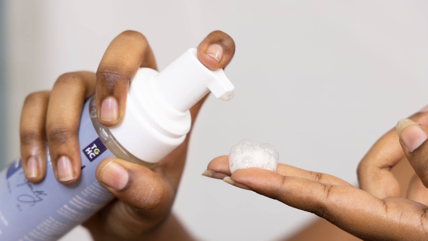 Hands dispensing a gentle foaming cleanser for sensitive skin