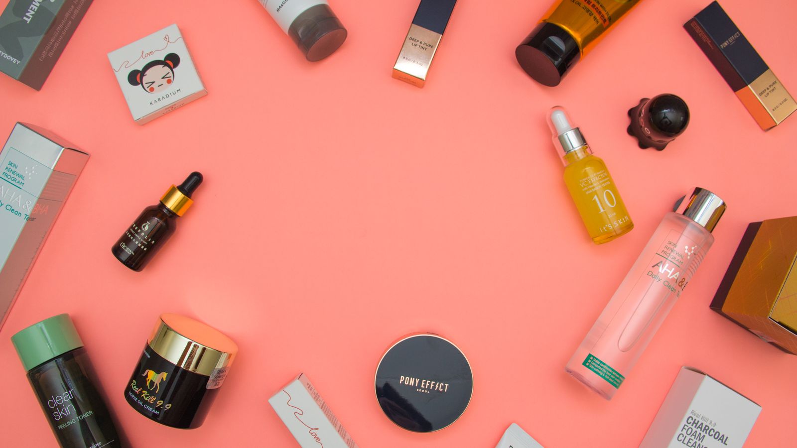 Skincare bottles and jars arranged flat, the core steps of a dermatologist recommended skincare routine