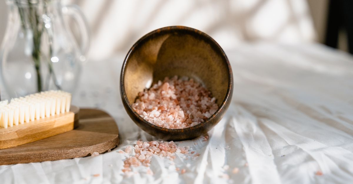 A wooden bowl of Epsom salt for hair, used as an occasional clarifying scalp scrub