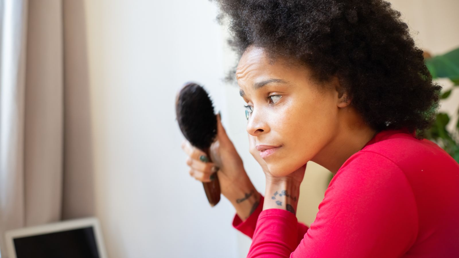 Woman brushing her hair gently, expert hair loss prevention tips