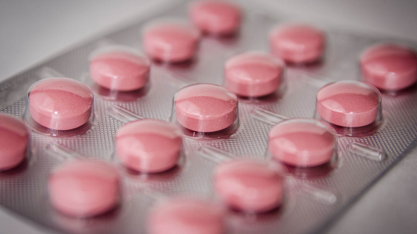 Prescription tablets in a blister pack representing finasteride for hair loss