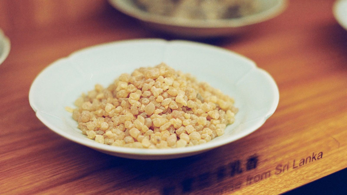 Frankincense resin in a bowl, the source of frankincense oil for hair and scalp care