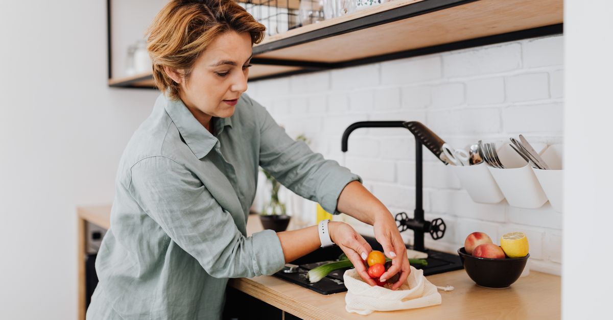 Woman preparing fresh vegetables, the everyday fix for hair shedding after weight loss in women