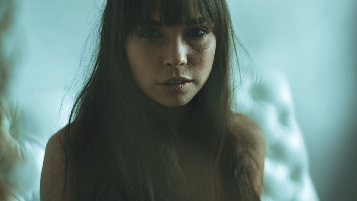 Woman with long hair and a soft fringe framing her face, hairline feminization through styling