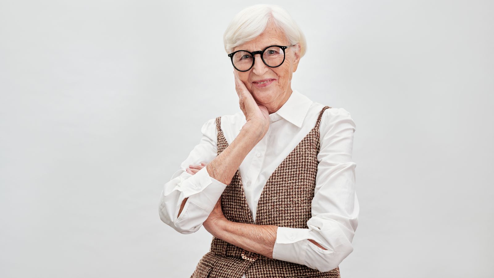 Confident smiling woman in her fifties, the age group most often asking about hormone therapy and hair growth