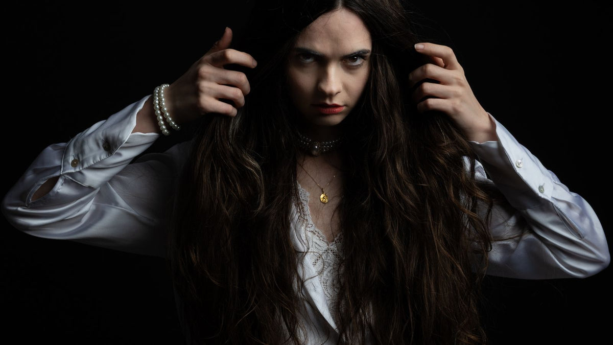 Woman holding her long hair back to show hormone therapy hairline changes