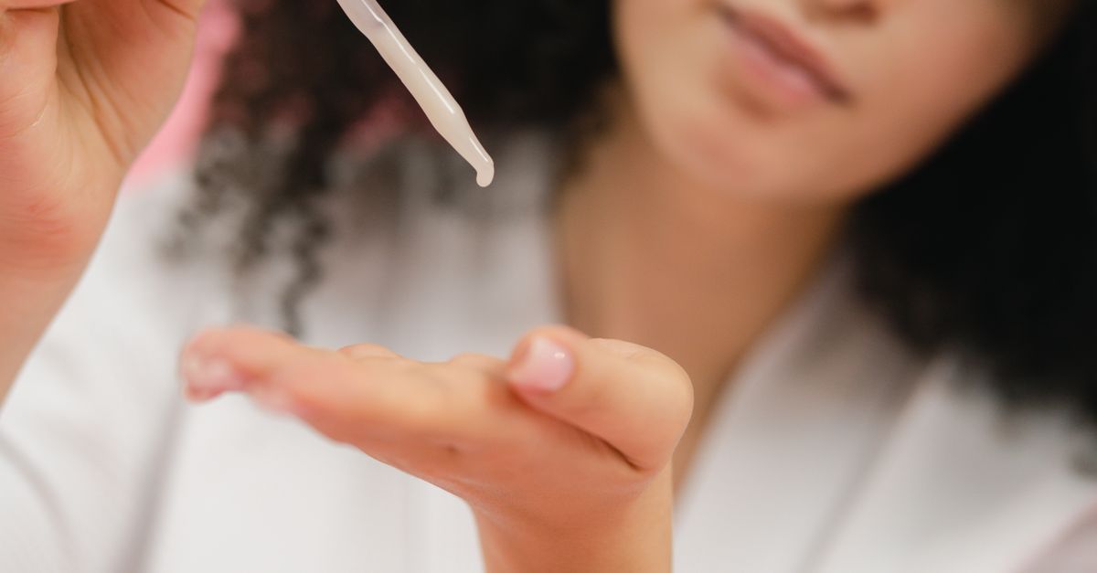 A dropper held against the skin, showing how much product to use on your scalp