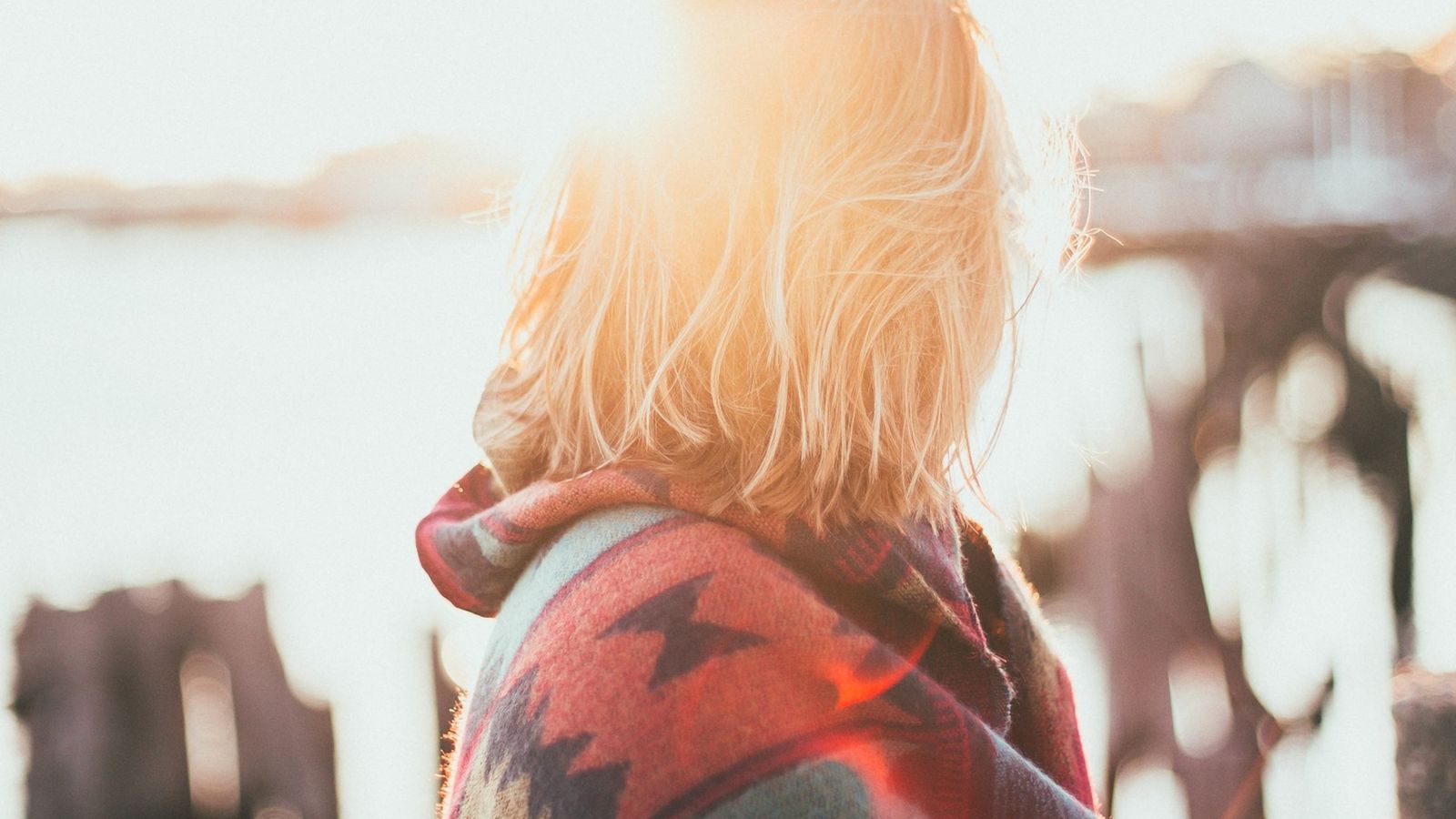 Woman with shiny healthy hair in the sunshine, the result of knowing how to get healthy hair