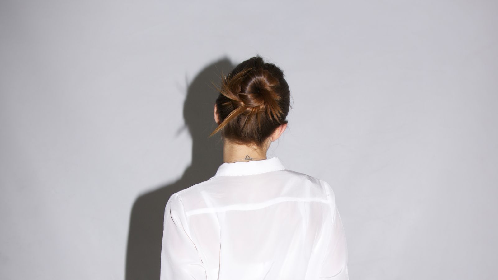 Woman with hair pulled back showing her natural hairline