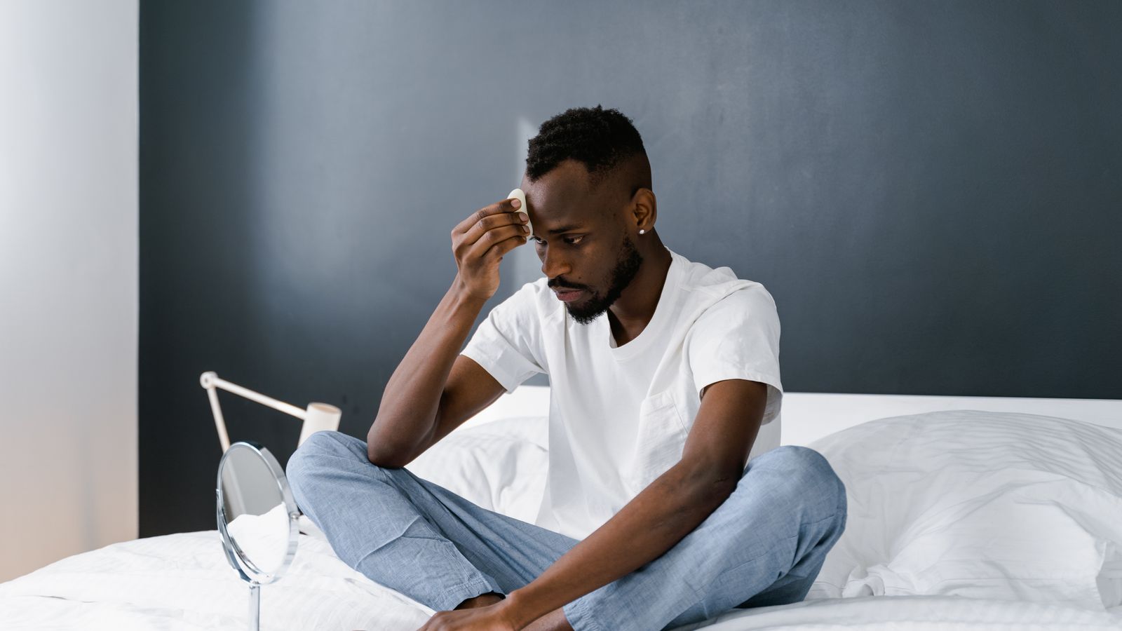 Man focusing on scalp and hair self-care, managing DHT for healthier hair