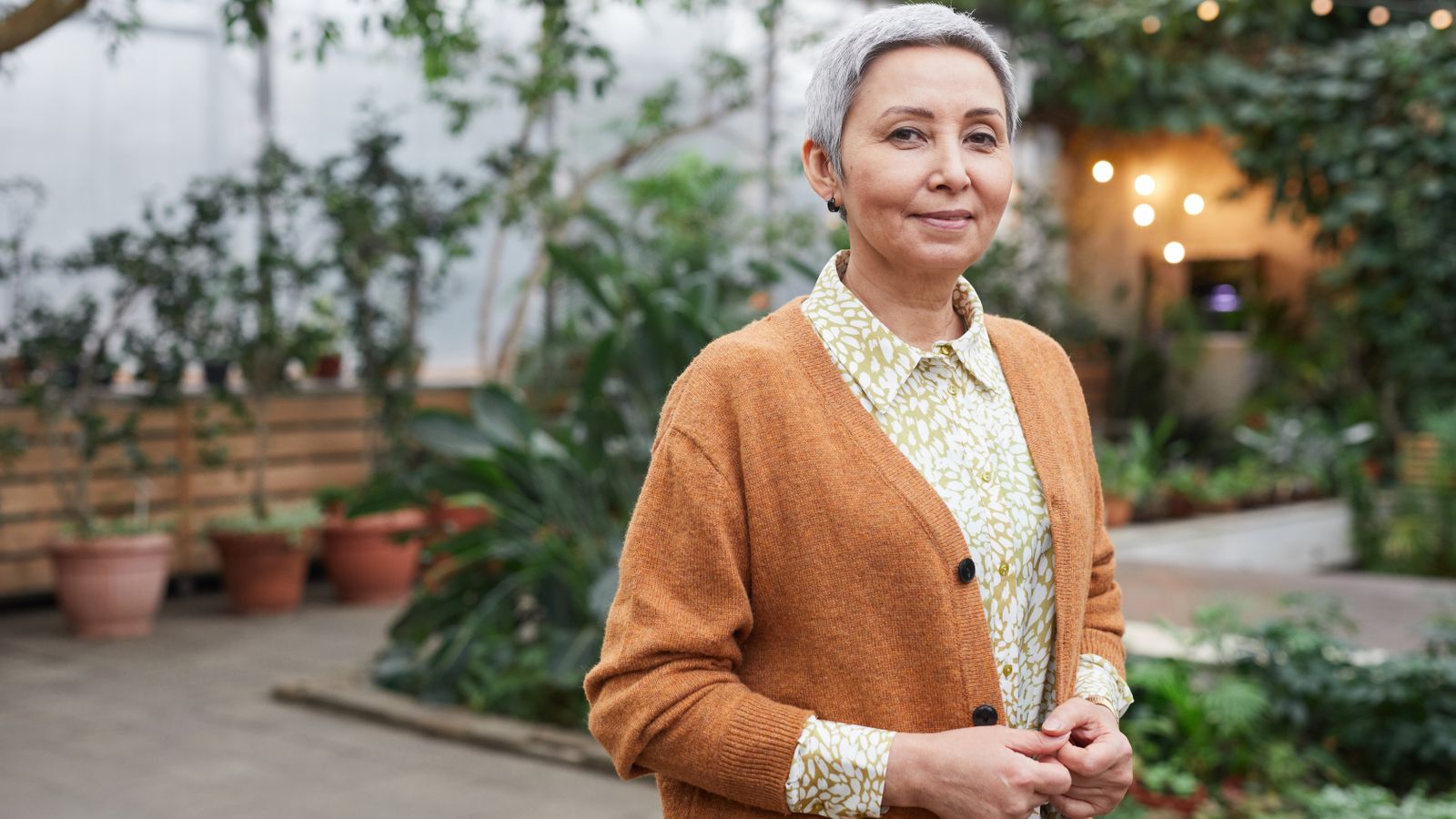 Smiling woman in her fifties, reassured after understanding HRT and hair loss