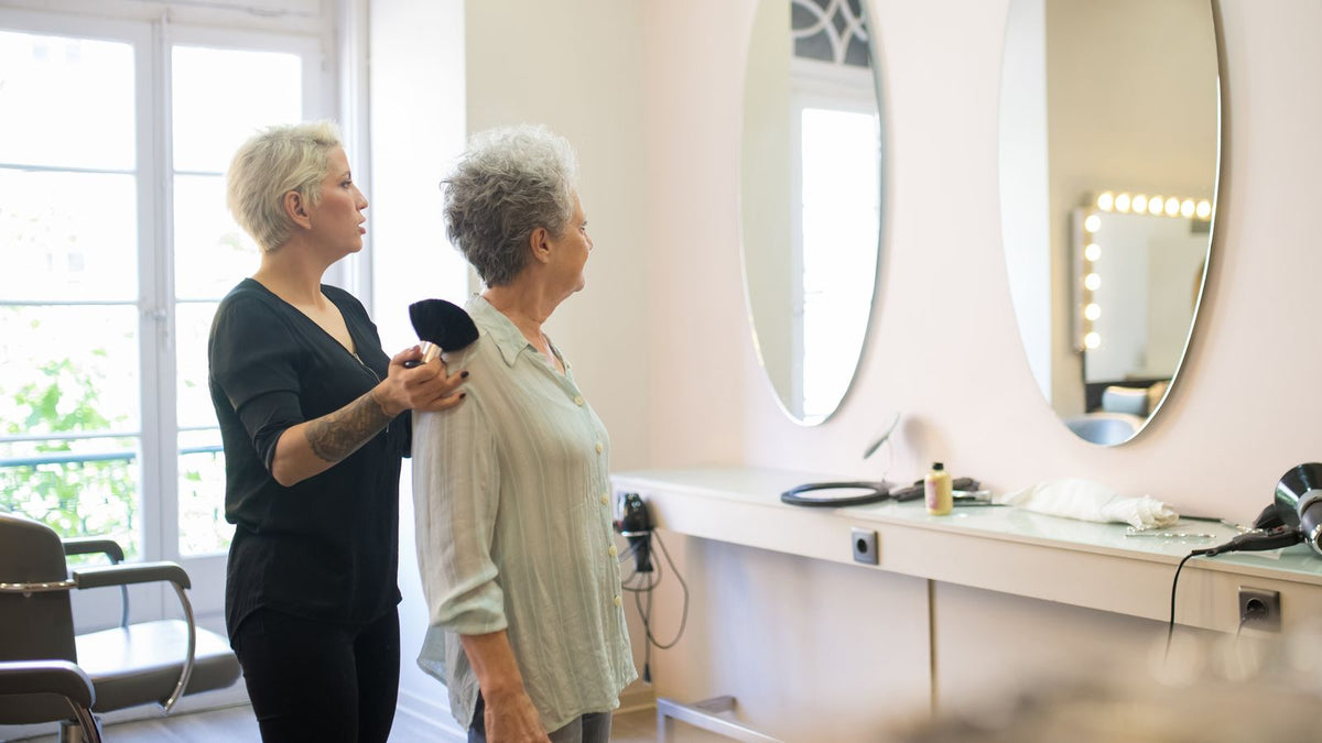 Woman in her fifties having her hair checked in a salon, tracking HRT hair density over time