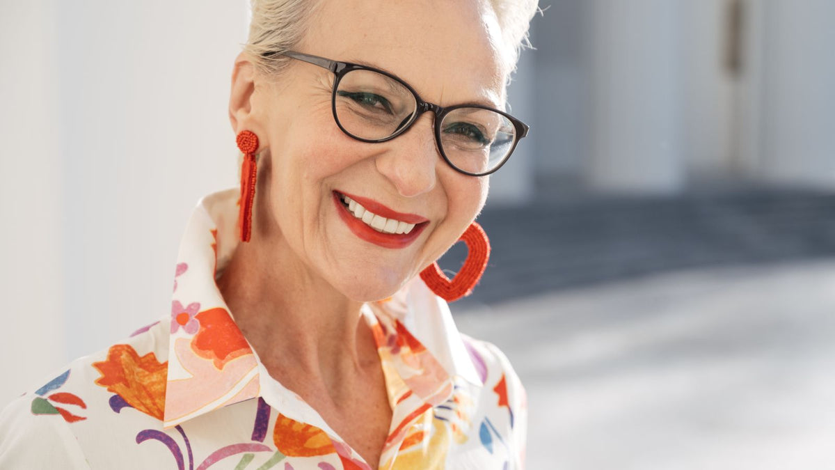 Smiling woman in her fifties, illustrating realistic HRT hair outcomes over time