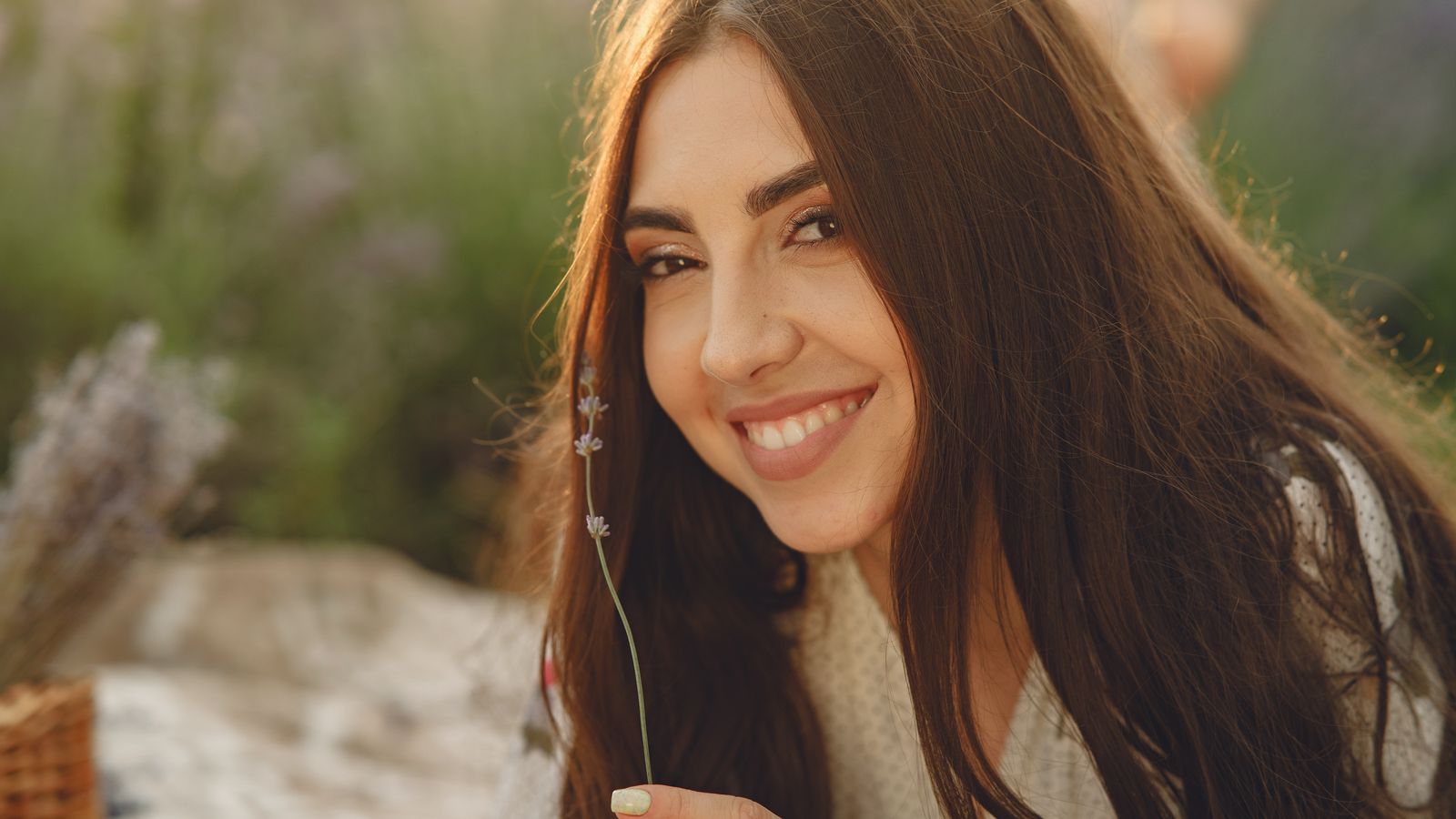Woman with long healthy hair outdoors, asking if I stop eating sugar will my hair grow back