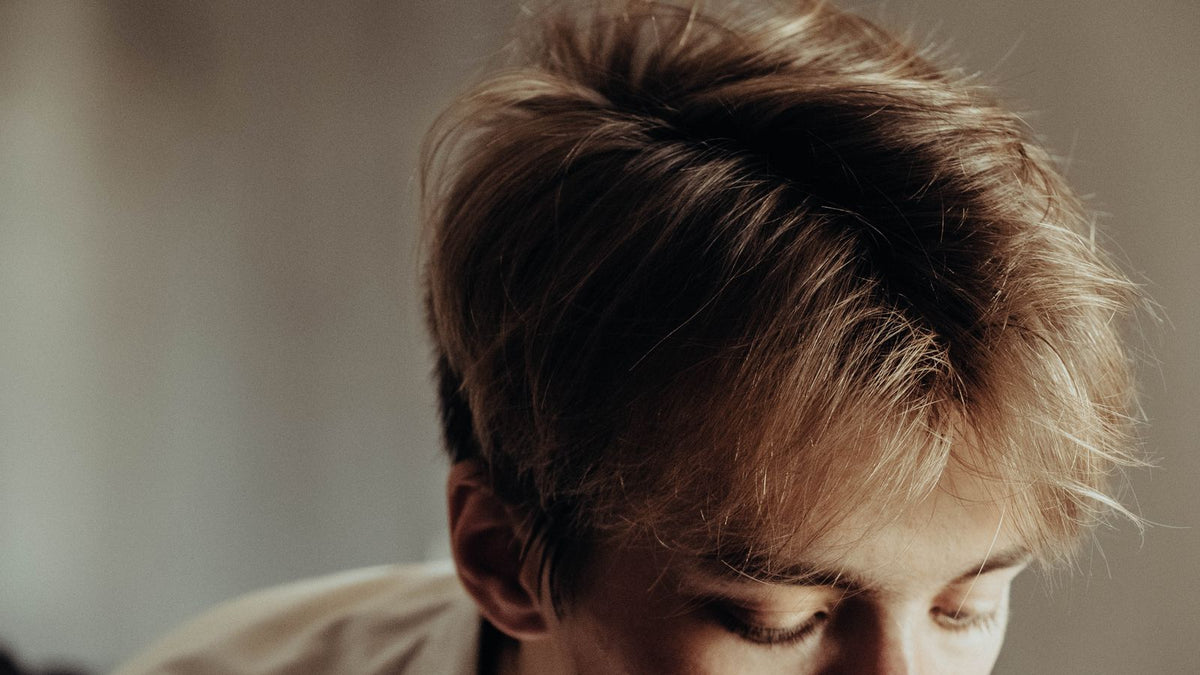 Man with tousled light brown hair showing the lift good styling gives fine hair
