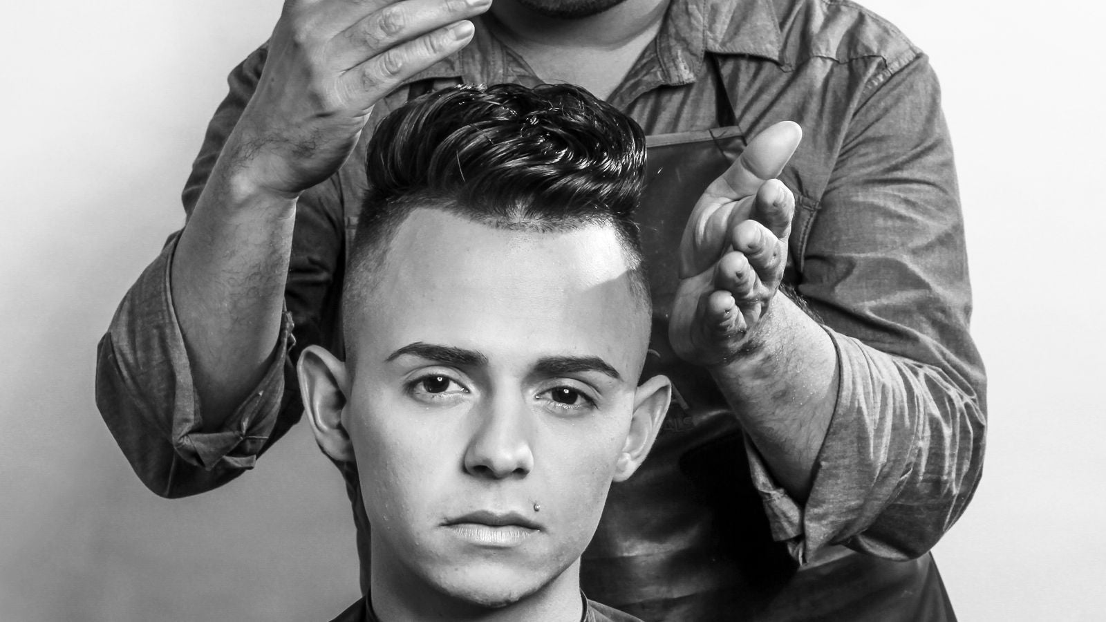 Stylist adding volume and texture to a man's hair