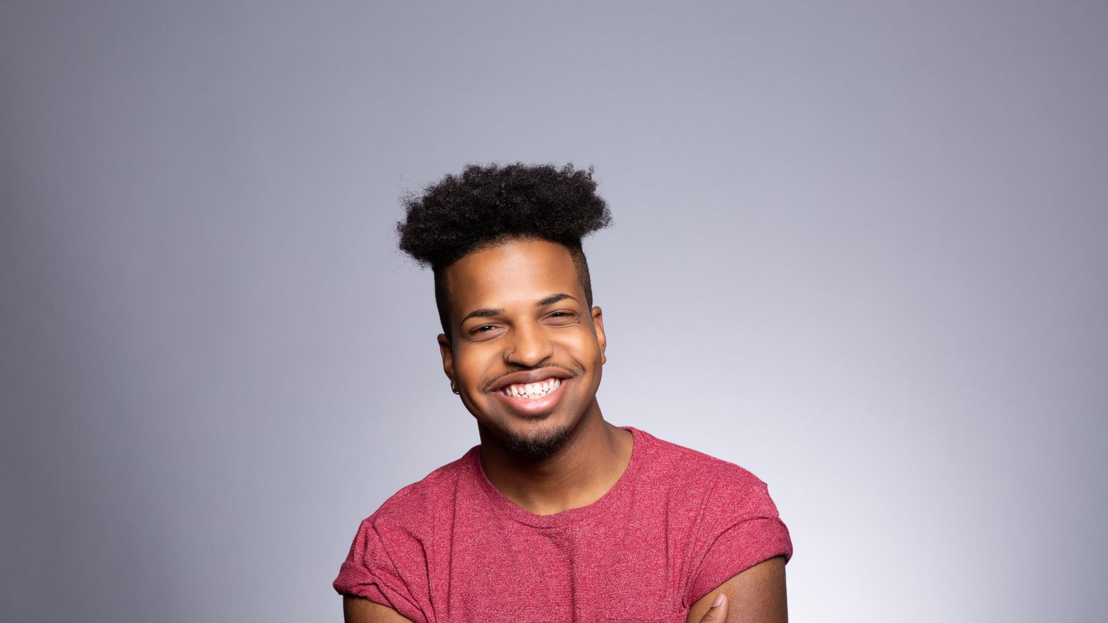 Confident Black man with natural curly hair, Joshua Dobbs inspired hairstyle