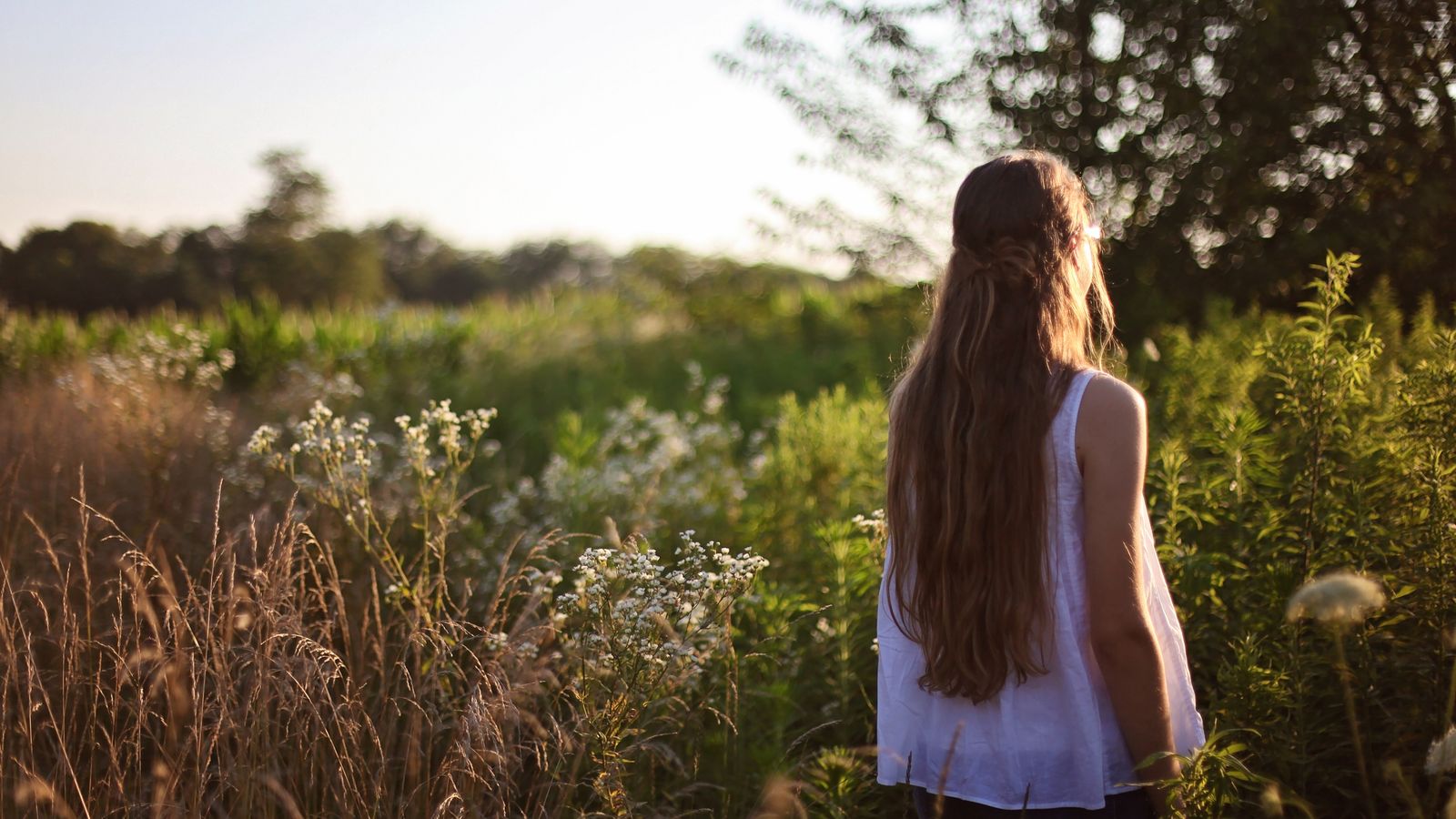 Woman with long healthy hair, liquid vitamins for hair growth