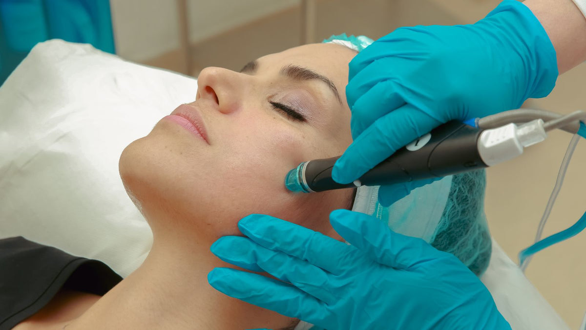 Microneedling vs dermarolling: a skincare device being used by a trained professional in a clinic setting