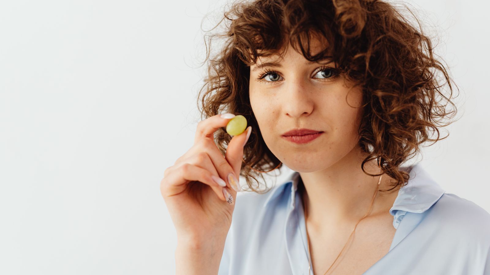 Woman with healthy hair holding fresh fruit, nutrition and hair loss