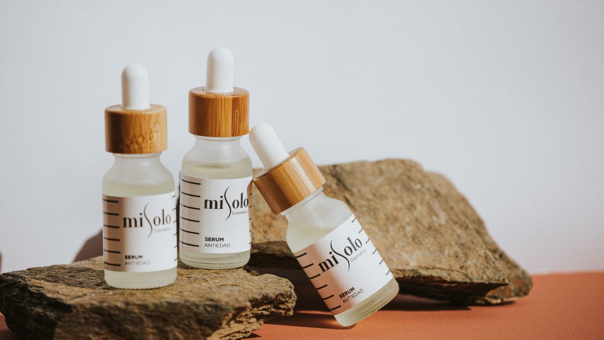 Dropper bottles of cosmetic serum on stone, the leave-on format that peptides for hair growth are usually sold in