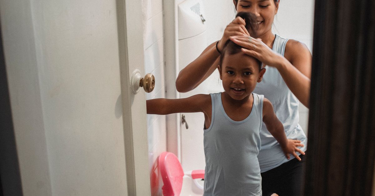 Woman styling her hair through postpartum regrowth