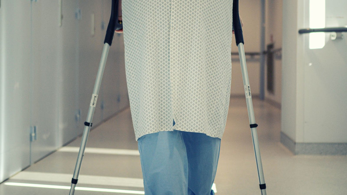 Person walking a hospital corridor at the start of the post-gonadectomy hair timeline