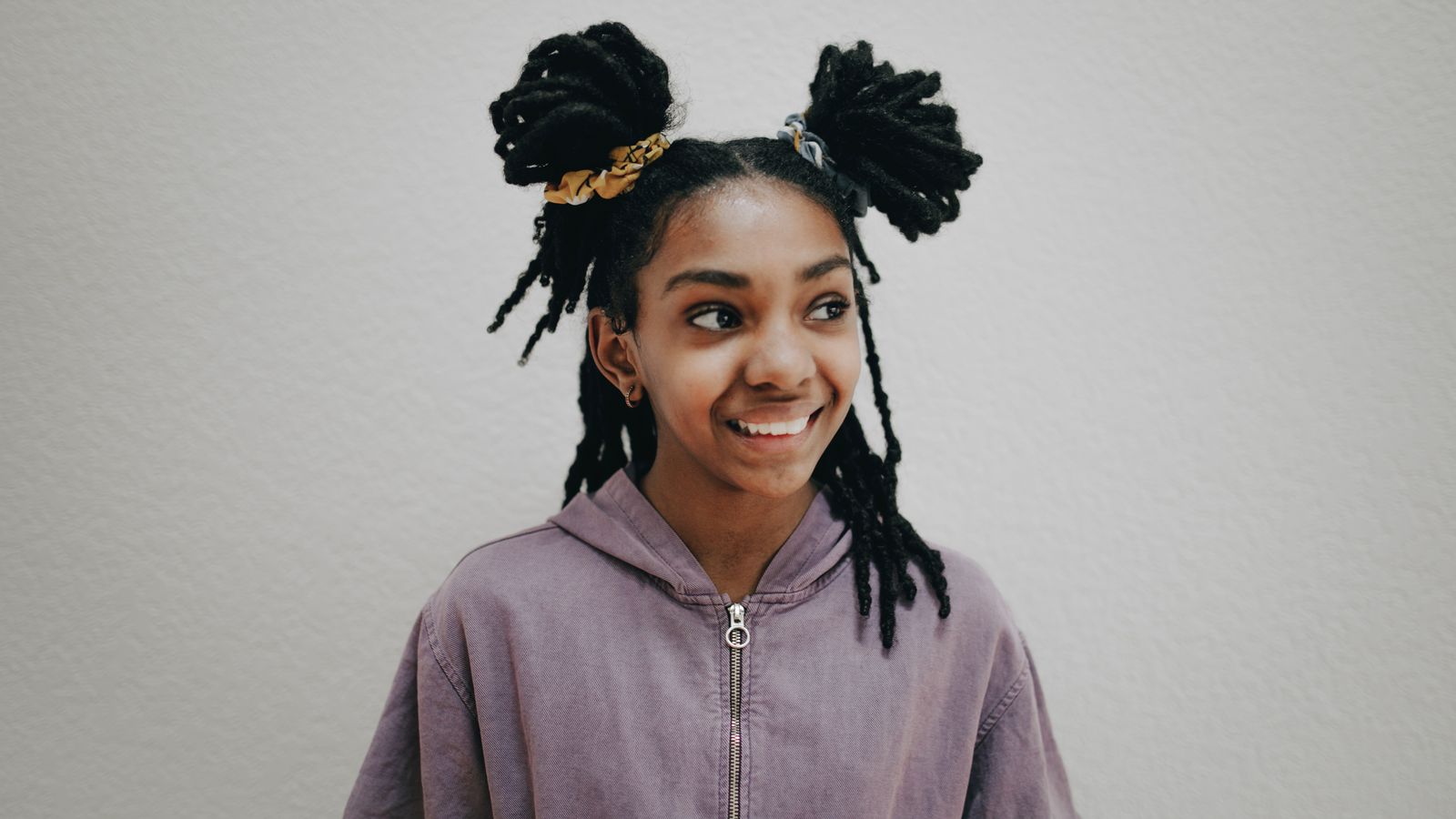 Person with healthy dreadlocks smiling