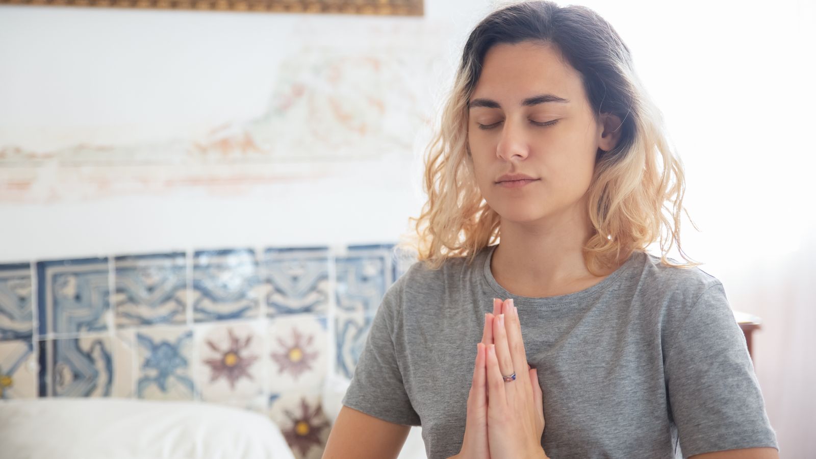 Woman meditating calmly, supporting recovery from stress-related hair loss