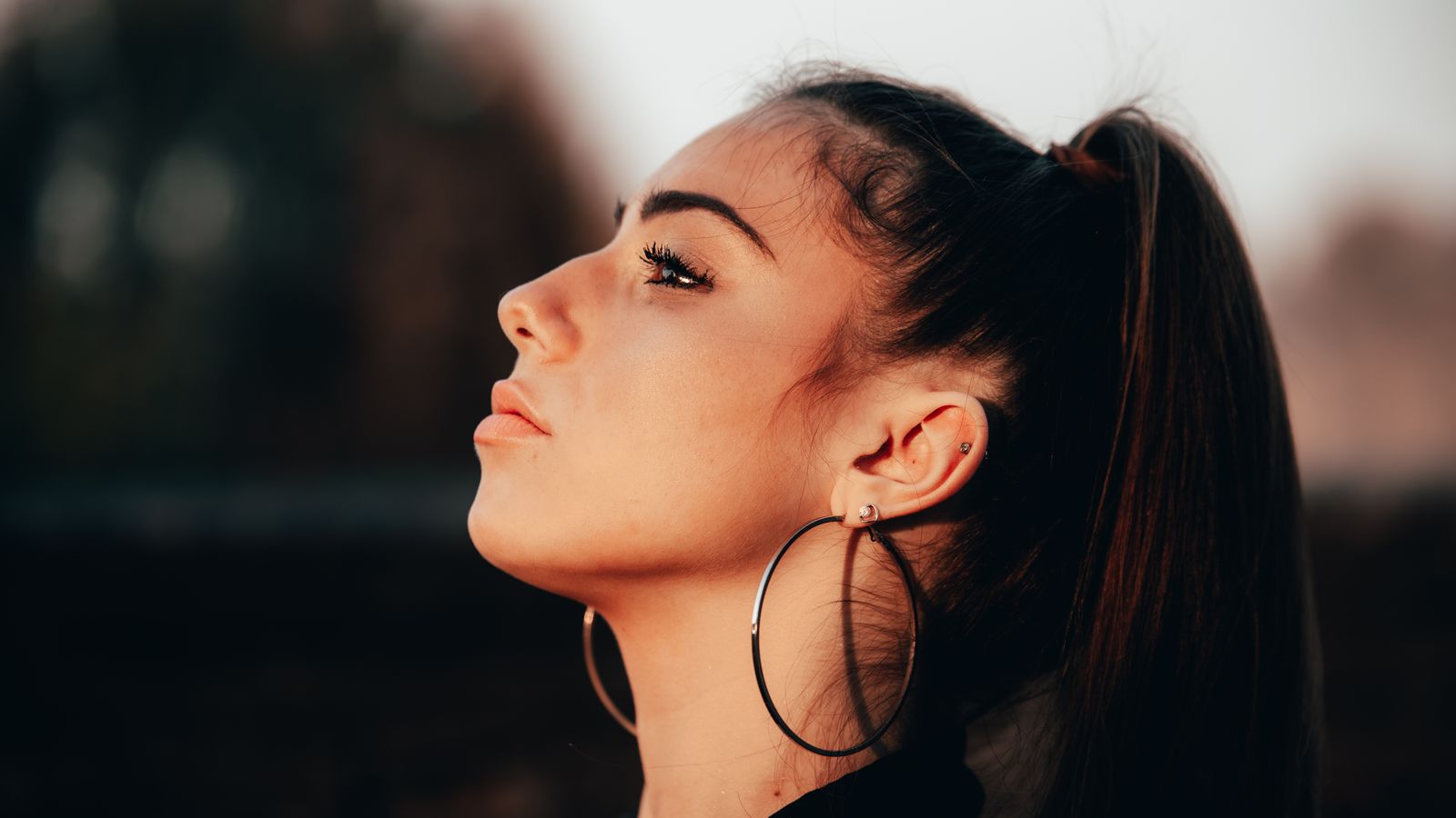 Side profile of a woman's temple and hairline area