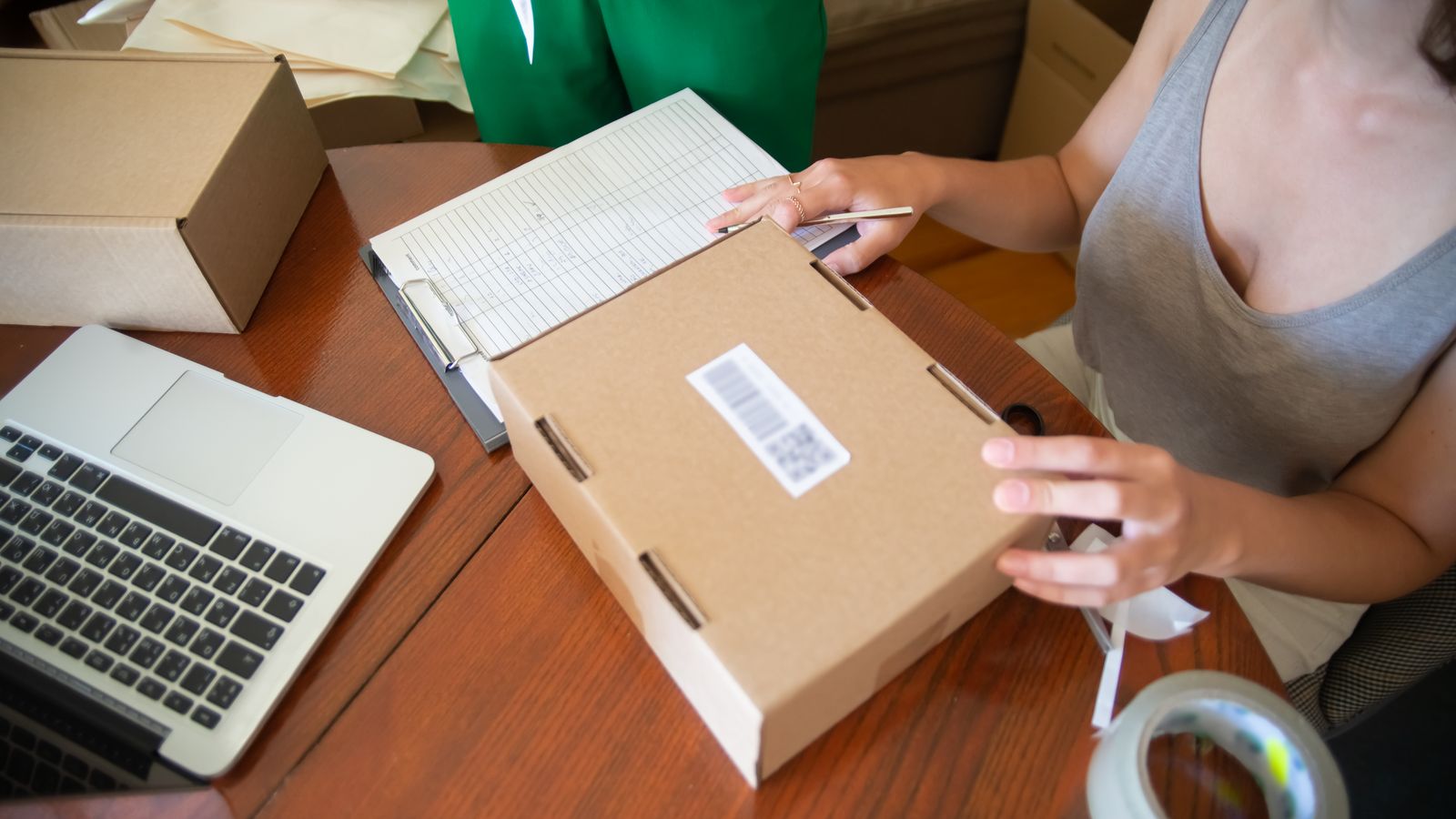 Parcels packed at a home desk after deciding to start hair growth oil business
