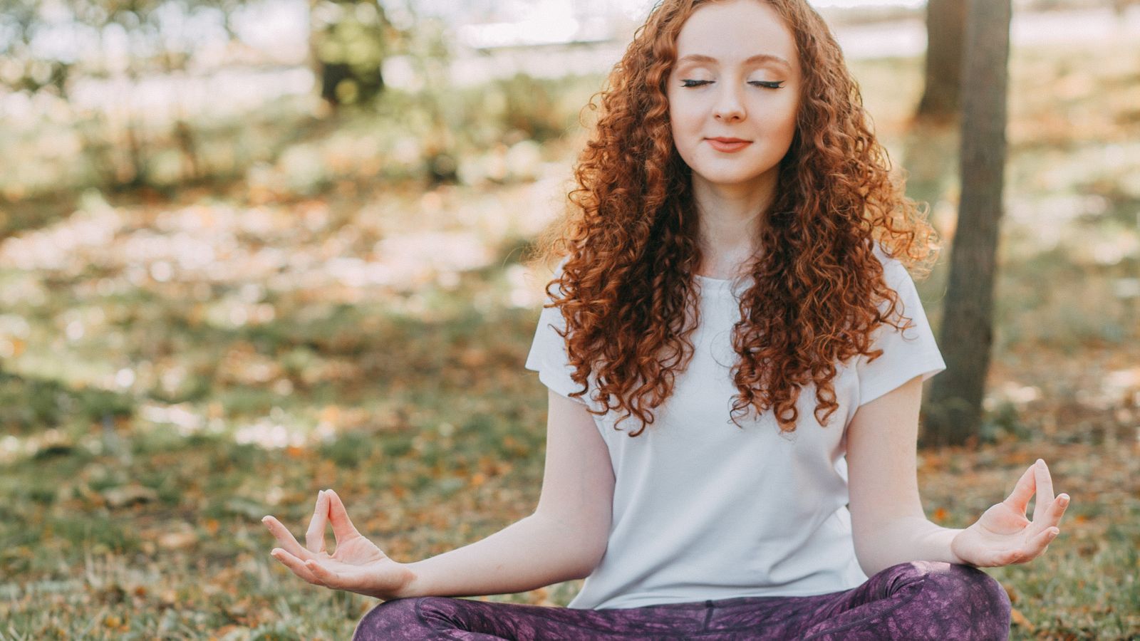 Woman meditating to reduce stress that can cause hair loss