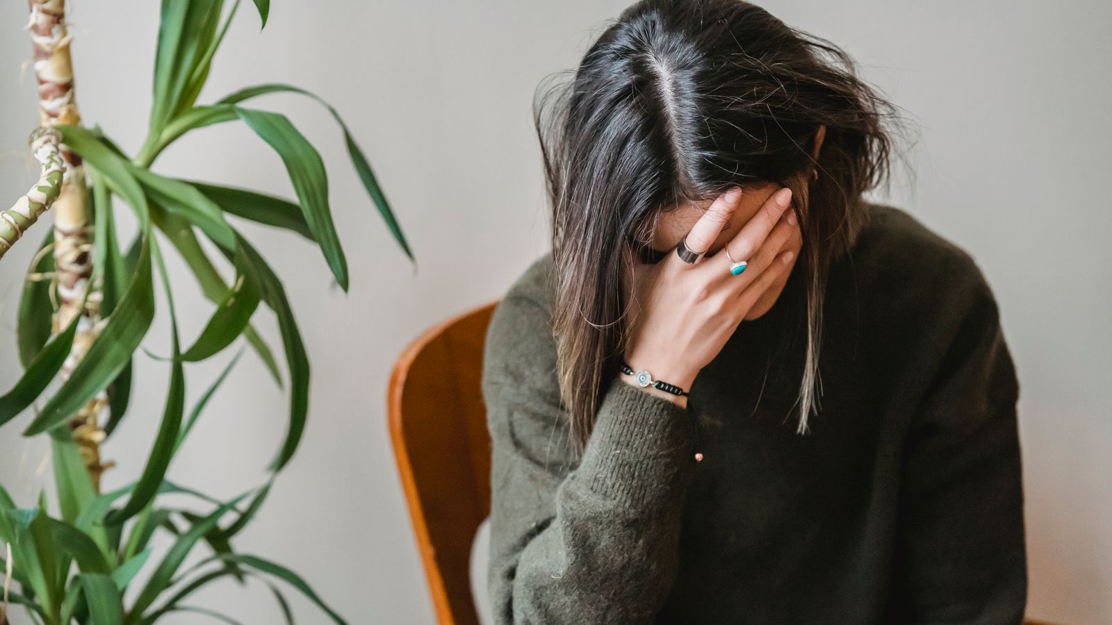 Worried woman experiencing sudden hair loss