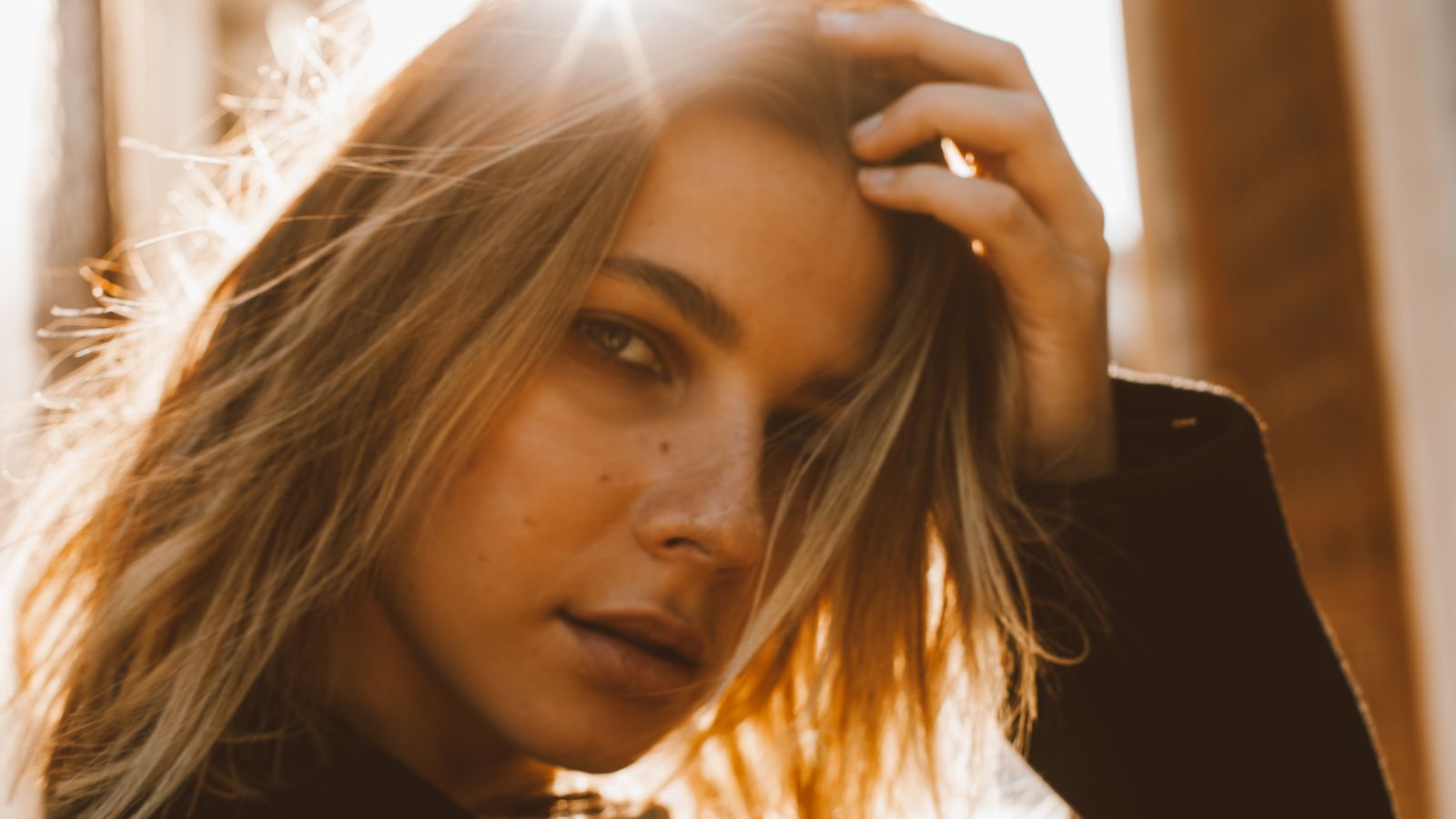 Sunlight shining through a woman's hair, which is how a sunburnt scalp usually starts