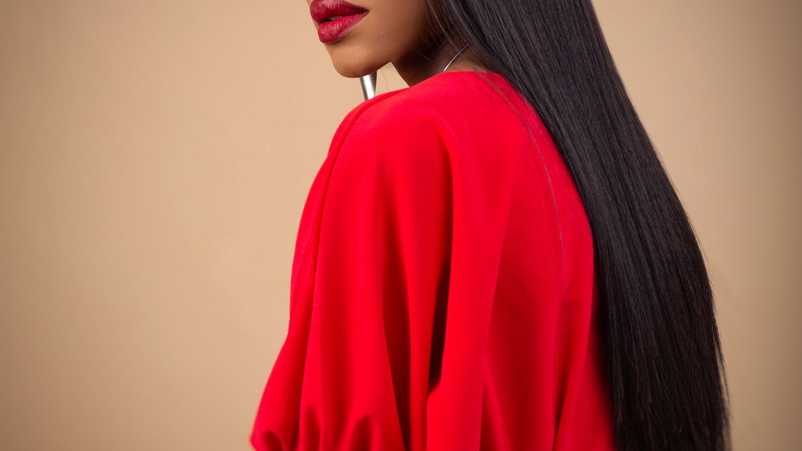 Woman with long dark hair, the top causes of hair loss explained