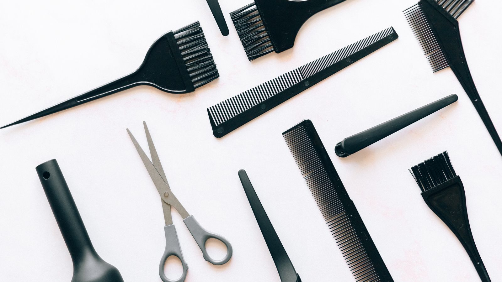 Brushes and combs laid out, the everyday tools that first reveal the top causes of hair loss