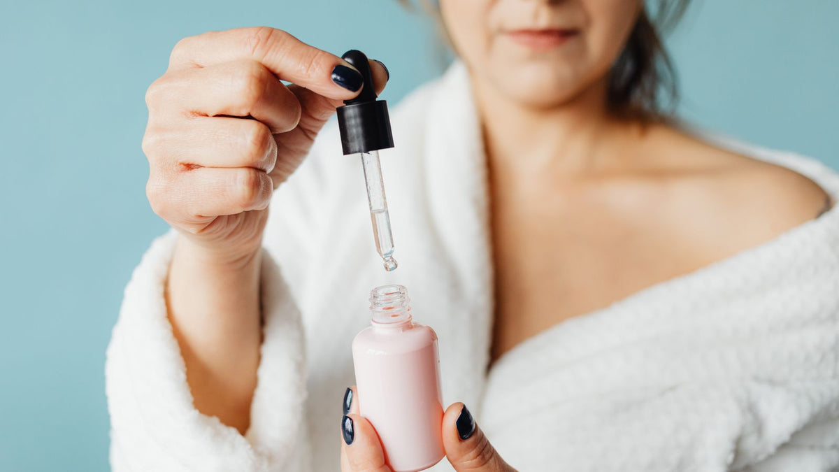 Woman applying a serum with a pipette, the usual format for topical melatonin products