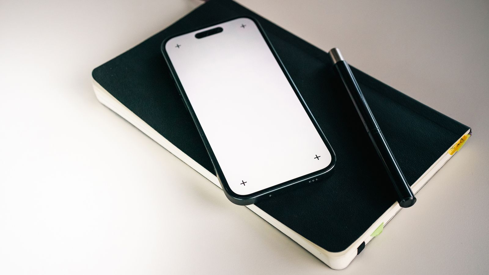 Notebook and smartphone set up to track hair growth treatment results