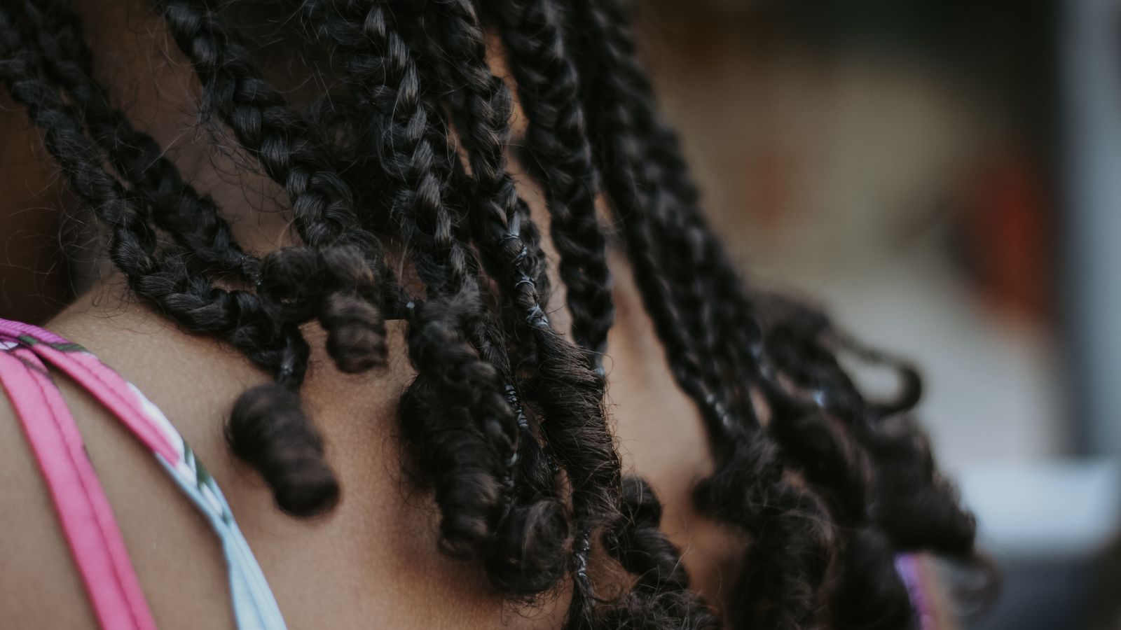 Close-up of a braided hairstyle, the styling tension behind traction alopecia