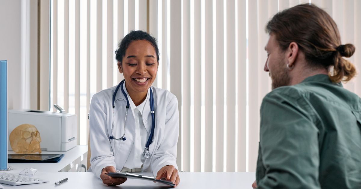 Doctor and patient in a bright clinic discussing transgender alopecia treatment options