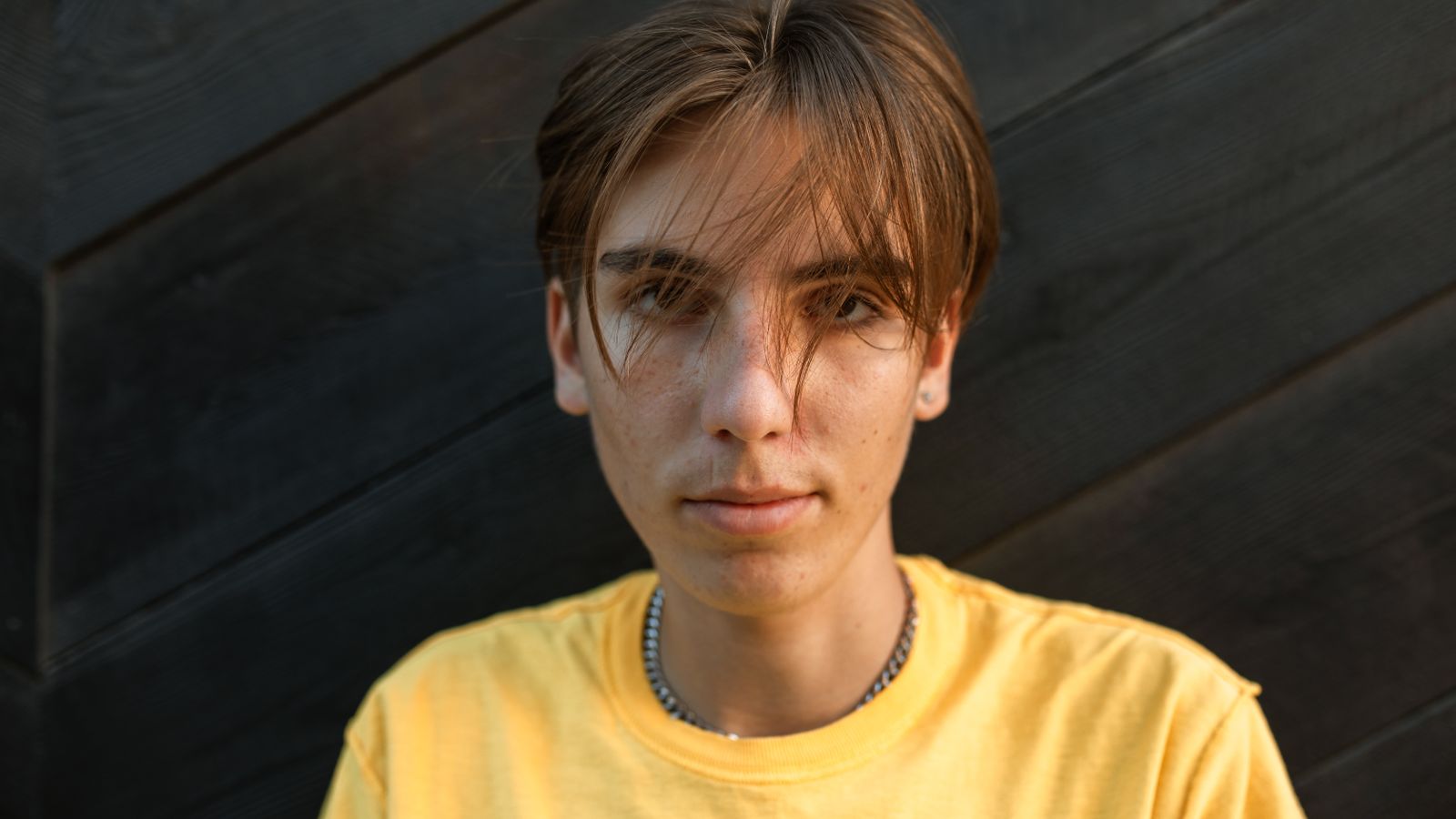 Confident person standing outdoors, transgender hair follicles change with gender-affirming hormone therapy