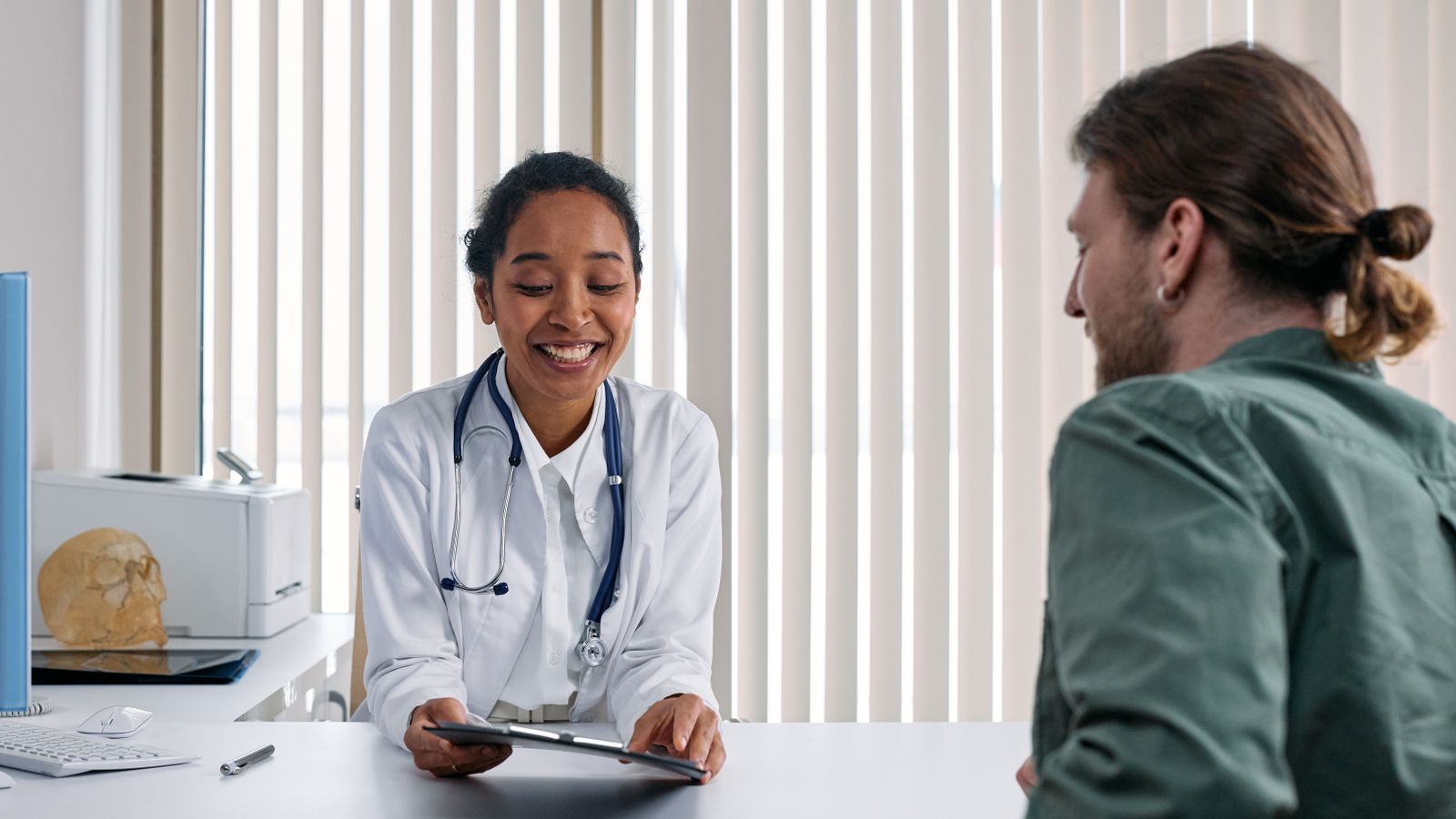 Doctor and patient in a bright clinic consultation, the first step before any transgender hair transplant