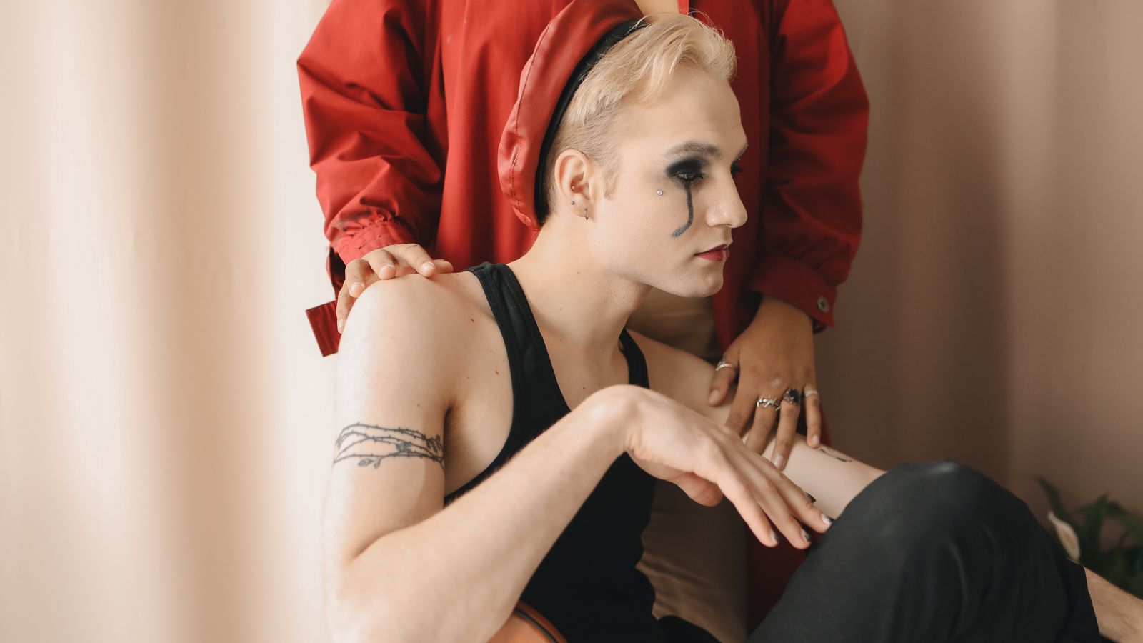 Person following a transgender HRT hair regimen sitting thoughtfully indoors