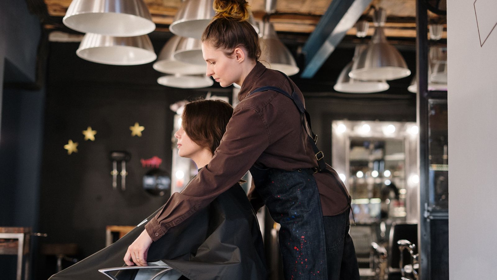 Hair specialist working with a client in a contemporary salon, similar to a trichologist appointment near Burnley